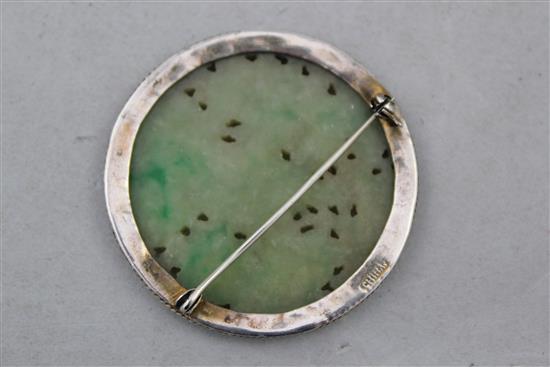 A Chinese jadeite circular plaque, 19th century, 5cm diam.